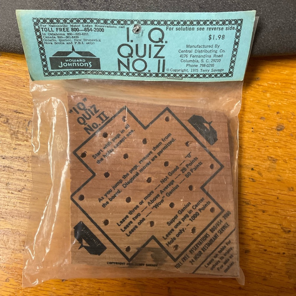 Wooden Puzzle Game with Orange Pegs Howard Johnson’s